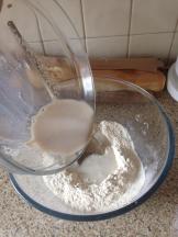 Addition of yeast, water, milk mix to flour